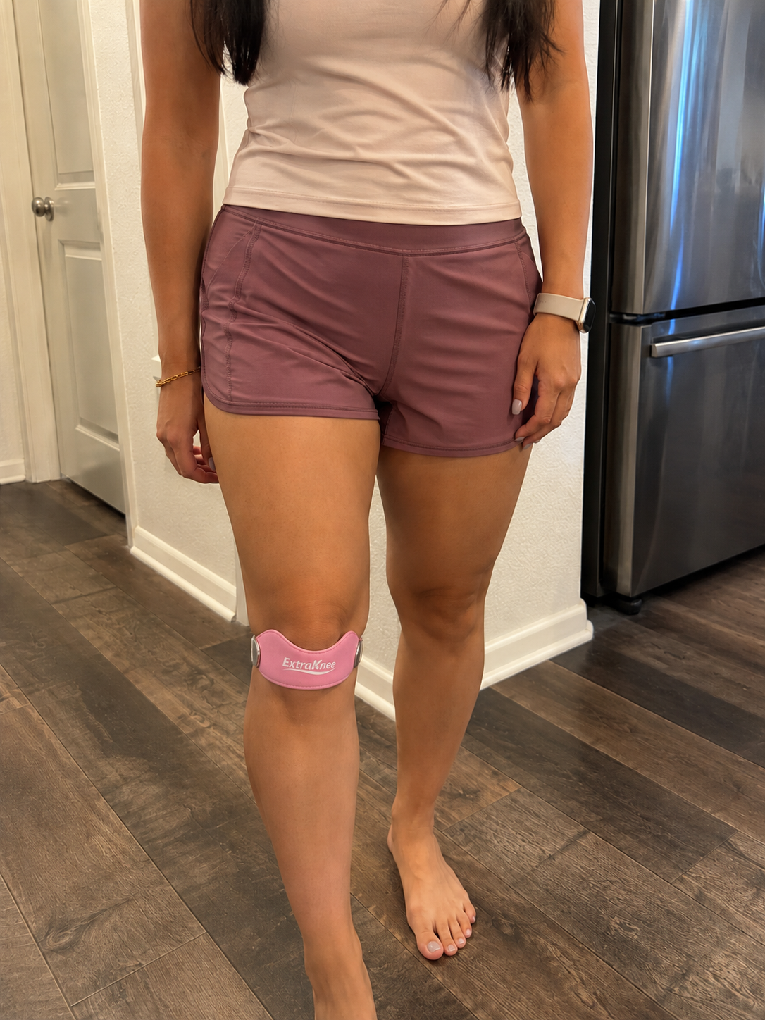 Pink ExtraKnee strap worn at home